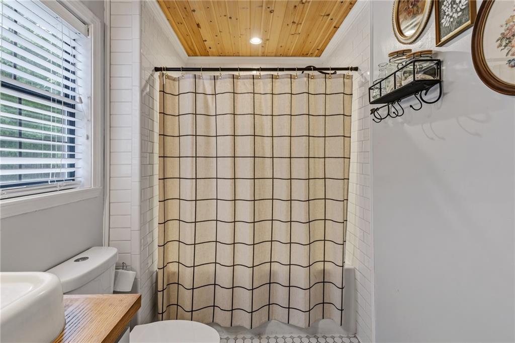 2700 Jack Glass Road Monroe, GA 30656 - Photo 19 of 48 a bathroom with a toilet and a shower curtain
