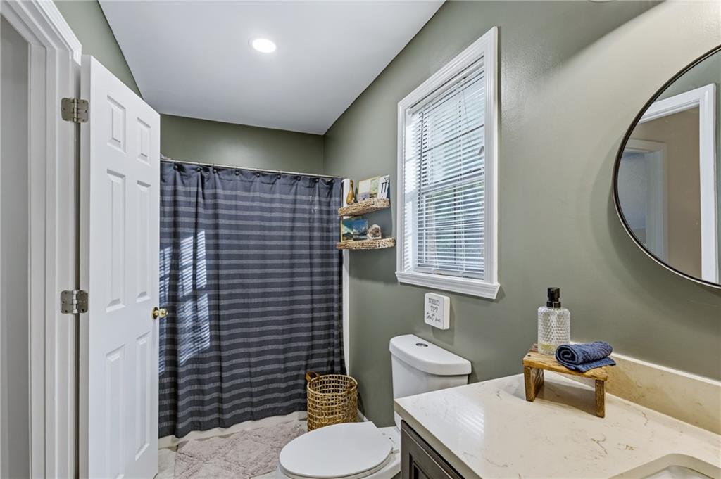 2700 Jack Glass Road Monroe, GA 30656 - Photo 21 of 48 a bathroom with a toilet a sink and mirror