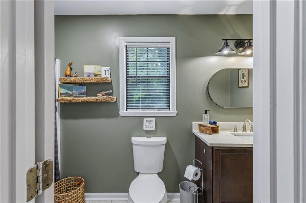 2700 Jack Glass Road Monroe, GA 30656 - Photo 23 of 48 a bathroom with a toilet a sink and mirror