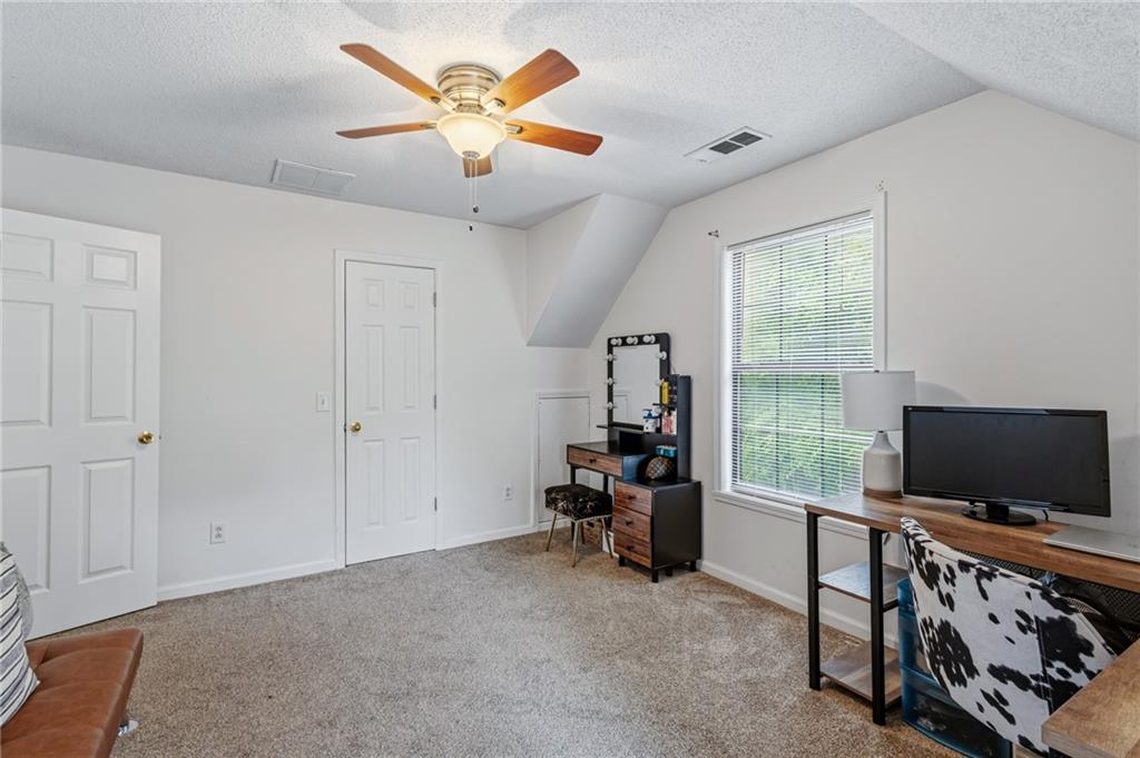 2700 Jack Glass Road Monroe, GA 30656 - Photo 26 of 48 a living room with furniture and a flat screen tv
