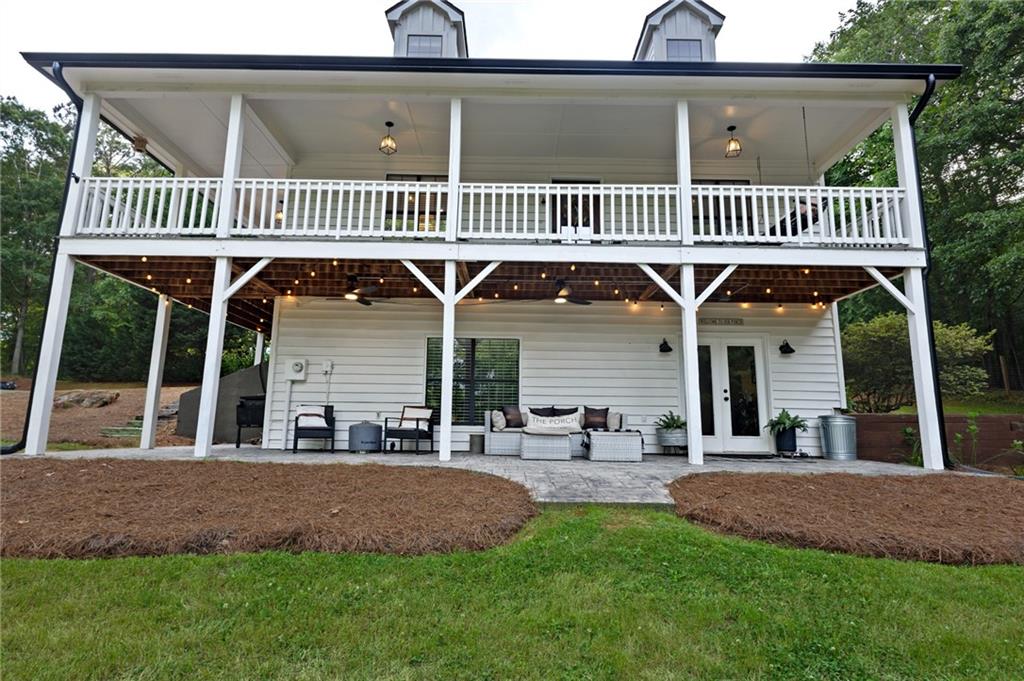 2700 Jack Glass Road Monroe, GA 30656 - Photo 39 of 48 a view of a roof deck with chair and wooden fence