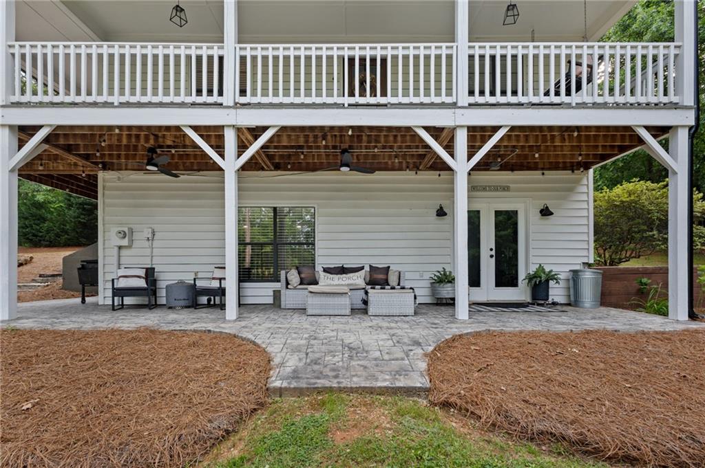2700 Jack Glass Road Monroe, GA 30656 - Photo 40 of 48 a roof deck with table and chairs and wooden fence