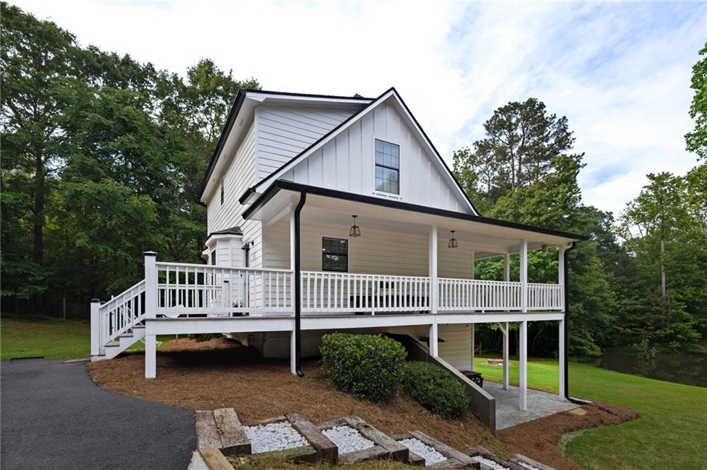 2700 Jack Glass Road Monroe, GA 30656 - Photo 42 of 48 a view of a house with a wooden deck and a yard