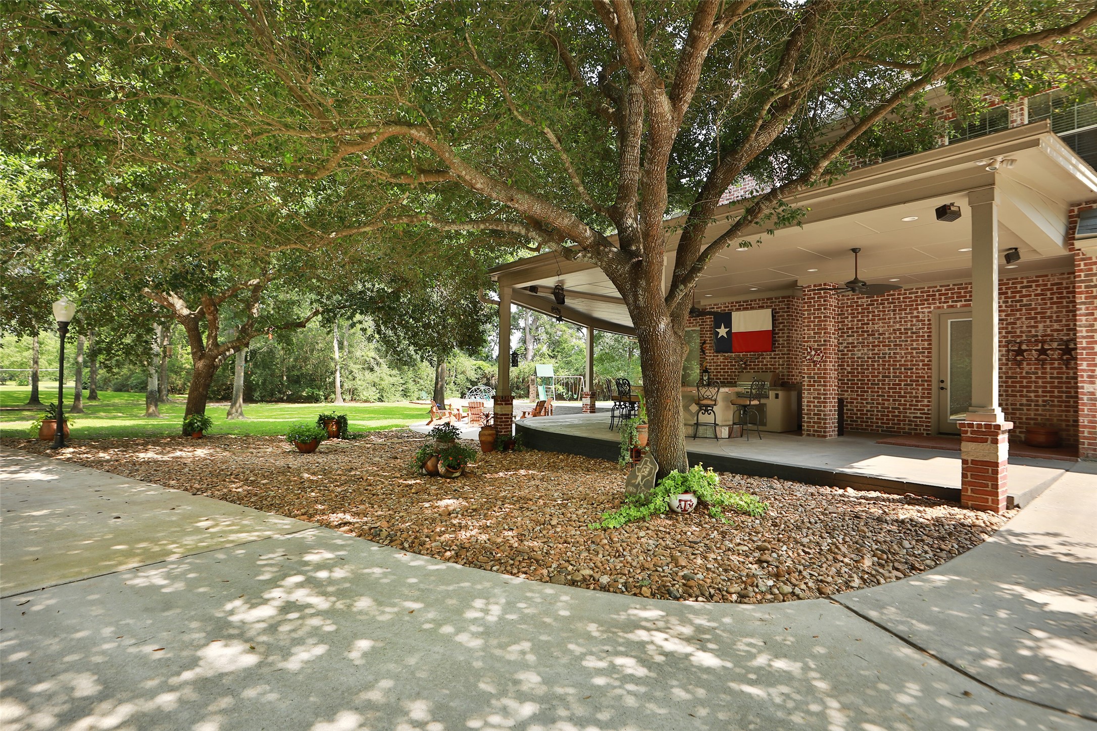12126 Zion Road Tomball, TX 77375 - Photo 8 of 45 View of the side yard looking at the firepit and outdoor kitchen.