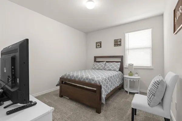 a bedroom with a bed and a mirror