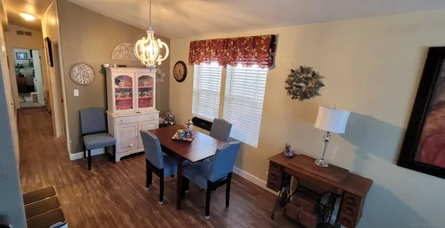 a view of a dining room with furniture and chandelier
