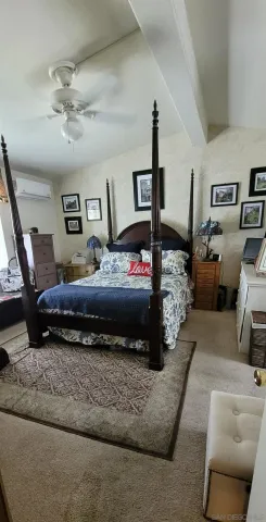 a bedroom with furniture and a chandelier