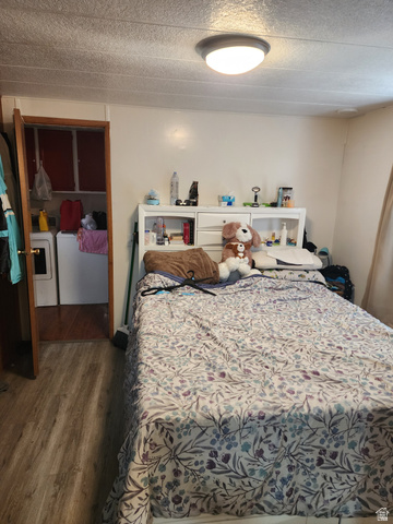 11362 Crescent Park Way, Unit 8 Sandy, UT 84070 - Photo 15 of 20 Bedroom featuring dark wood finished floors, washer / dryer, and a textured ceiling
