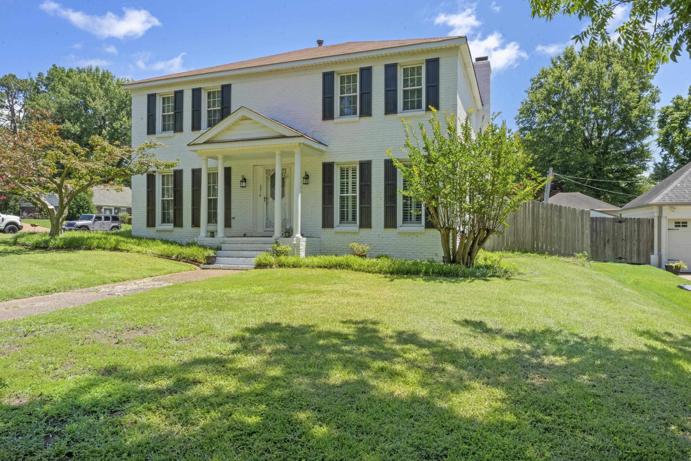 2218 Riverdale Road Germantown, TN 38138 - Photo 40 of 40 Stately painted brick exterior with mature landscaping and inviting covered entry creates a lasting first impression.