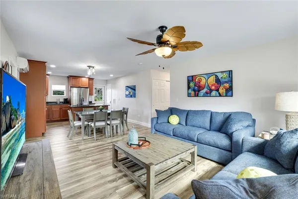 a living room with furniture kitchen view and a dining table
