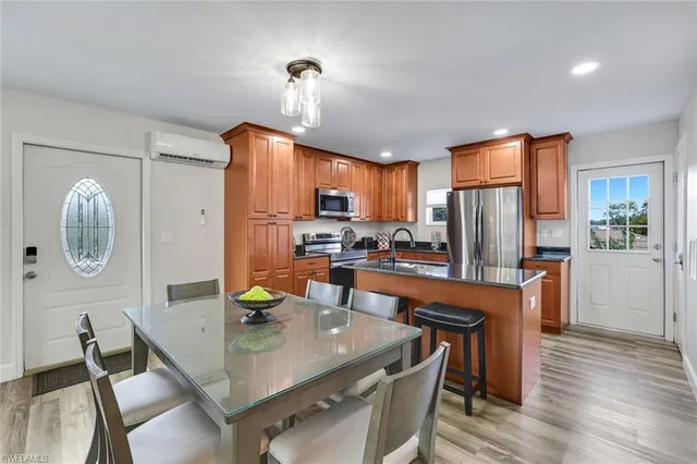 a bedroom with a bed a couch and a chandelier