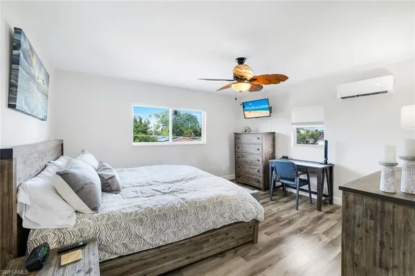 a bathroom with a sink a toilet a mirror and shower curtain