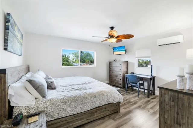 a bathroom with a sink a toilet a mirror and shower curtain