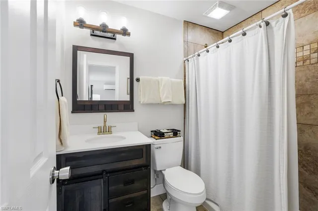 a bedroom with two beds and a chandelier