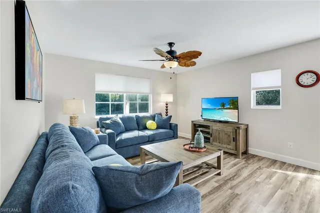 a kitchen with kitchen island granite countertop a sink stove and refrigerator