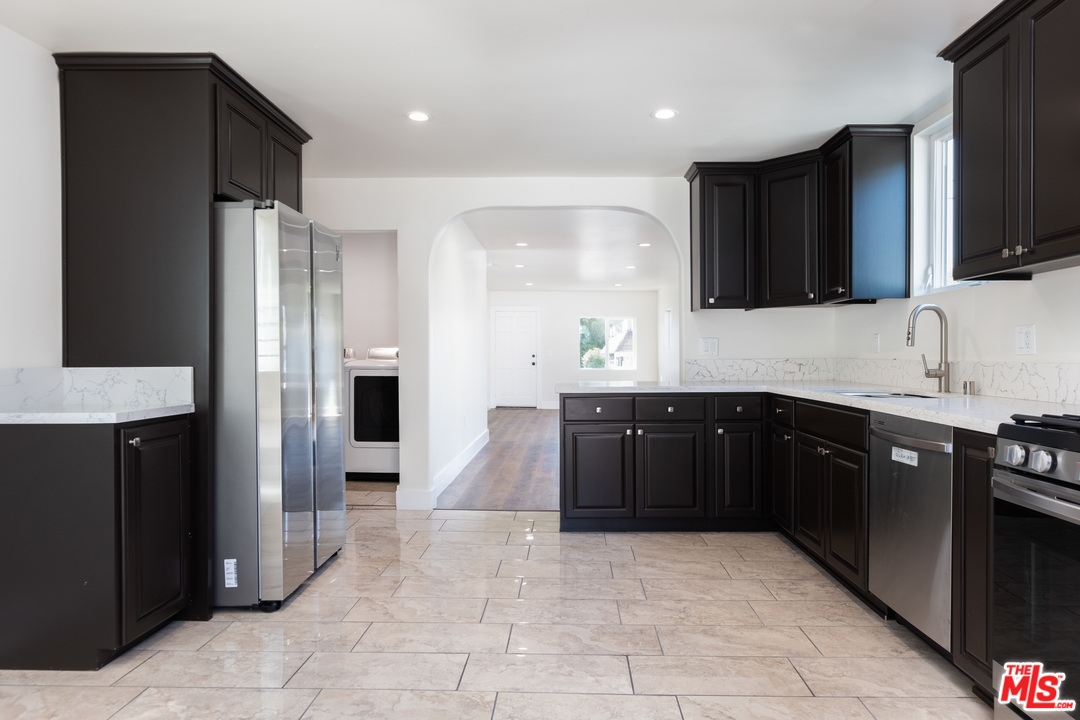 628 Silver Boulevard Los Angeles, CA 90026 - Photo 11 of 22 a kitchen with stainless steel appliances granite countertop a refrigerator and a stove top oven