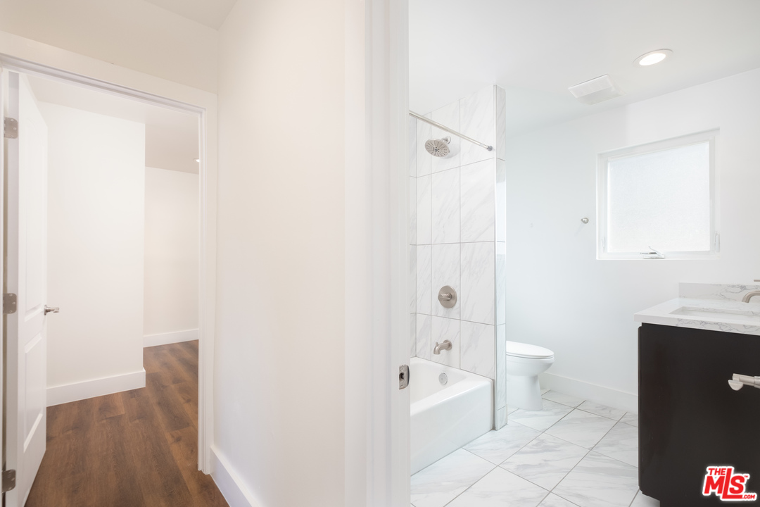 628 Silver Boulevard Los Angeles, CA 90026 - Photo 13 of 22 a spacious bathroom with a granite countertop sink a toilet and shower