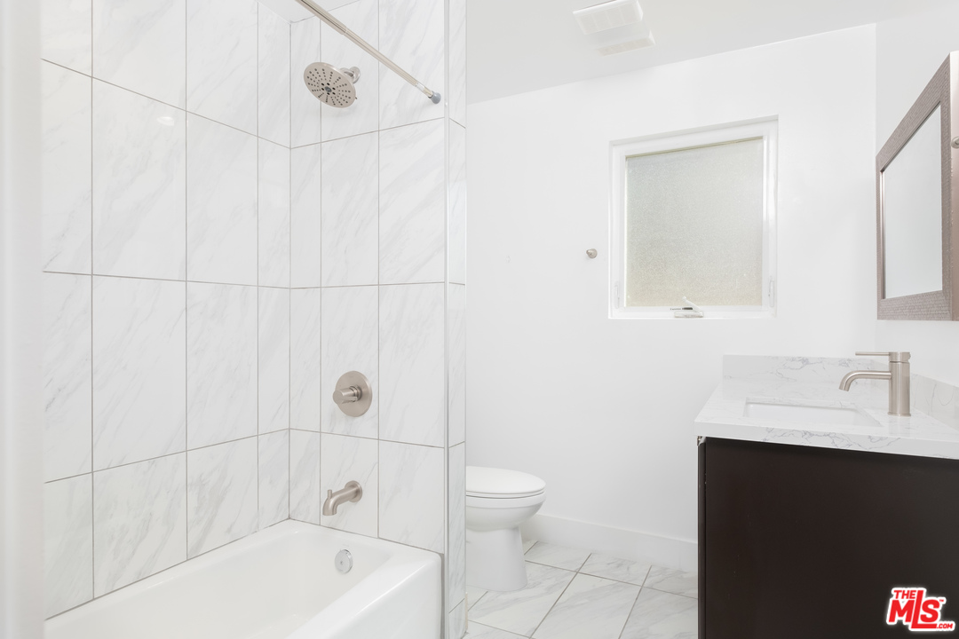 628 Silver Boulevard Los Angeles, CA 90026 - Photo 14 of 22 a bathroom with a sink a toilet and shower
