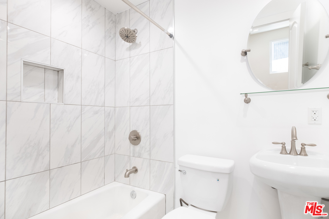 628 Silver Boulevard Los Angeles, CA 90026 - Photo 17 of 22 a bathroom with a sink a toilet and shower