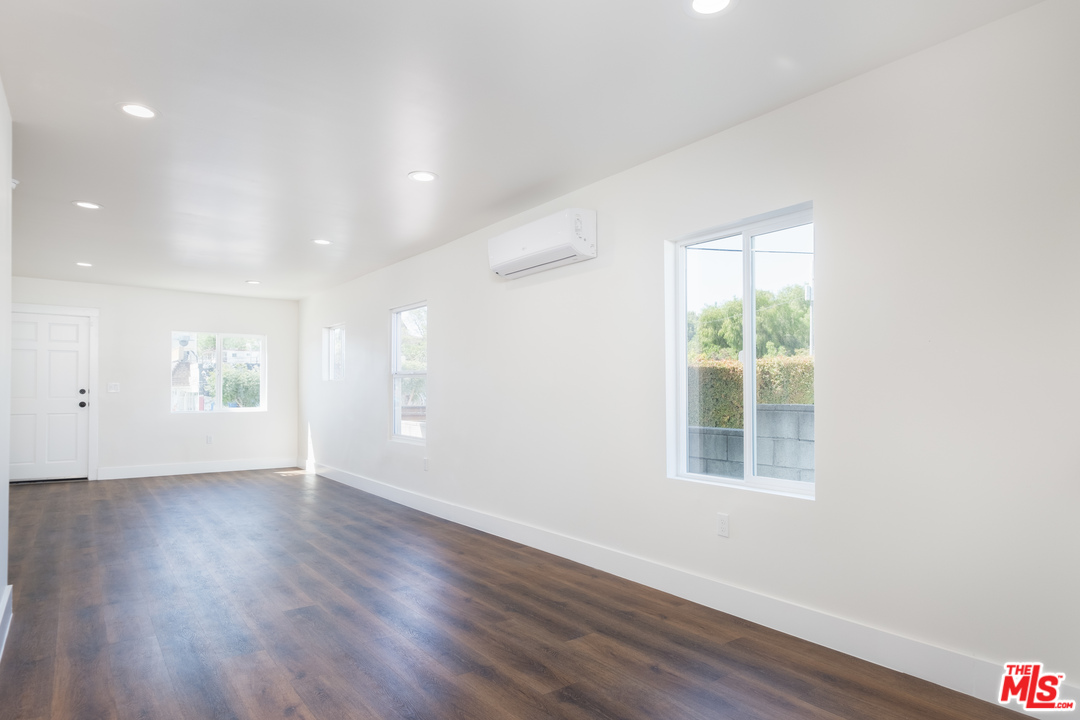 628 Silver Boulevard Los Angeles, CA 90026 - Photo 6 of 22 an empty room with wooden floor and windows
