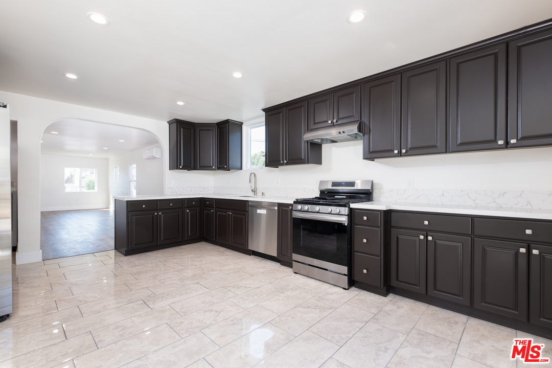 628 Silver Boulevard Los Angeles, CA 90026 - Photo 9 of 22 a kitchen with granite countertop a stove and cabinets