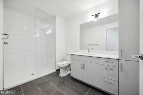 a bathroom with a toilet sink and shower