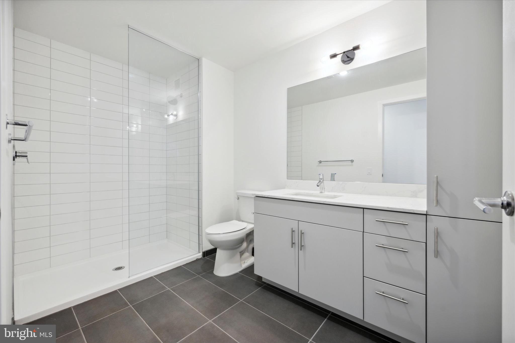 569 North 5th Street, Unit 830 Philadelphia, PA 19123 - Photo 10 of 46 a bathroom with a toilet sink and shower