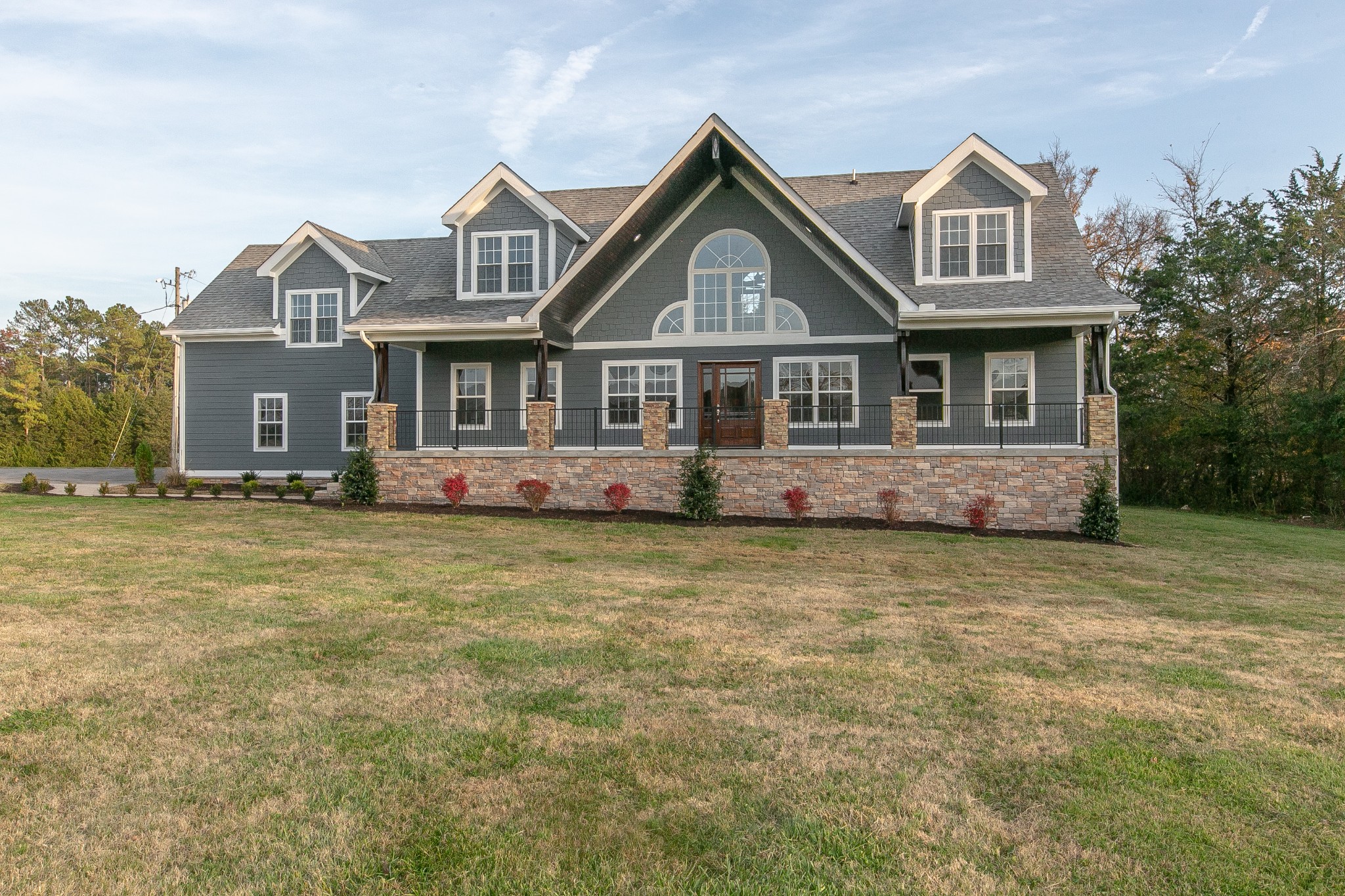 9130 Murfreesboro Road Lebanon, TN 37090 - Photo 1 of 1 a front view of a house with a garden and trees