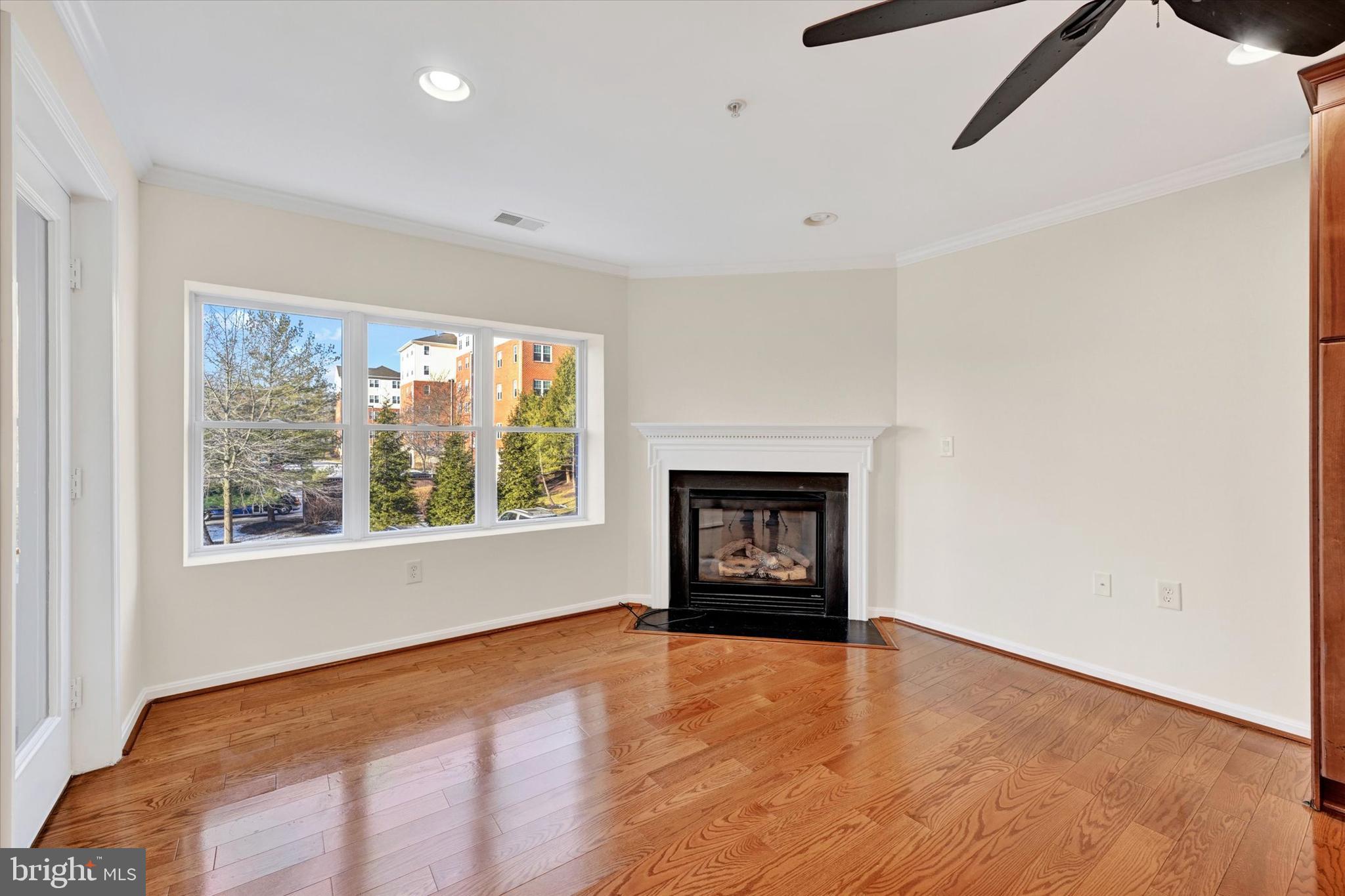 12236 Roundwood Road, Unit 104 Lutherville-Timonium, MD 21093 - Photo 11 of 27 a view of an empty room with a window and a fireplace