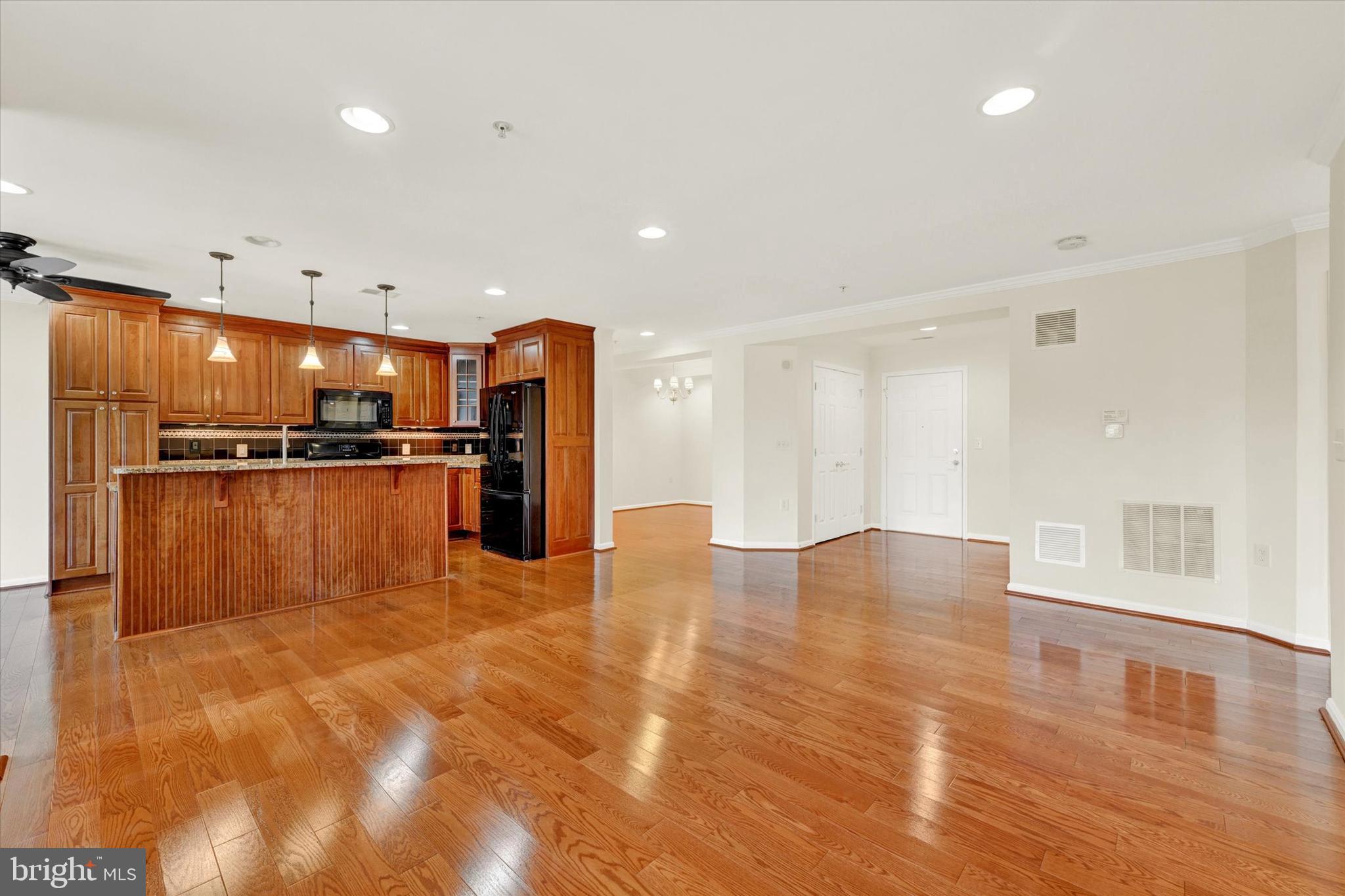 12236 Roundwood Road, Unit 104 Lutherville-Timonium, MD 21093 - Photo 13 of 27 a view of kitchen with refrigerator cabinets and wooden floor