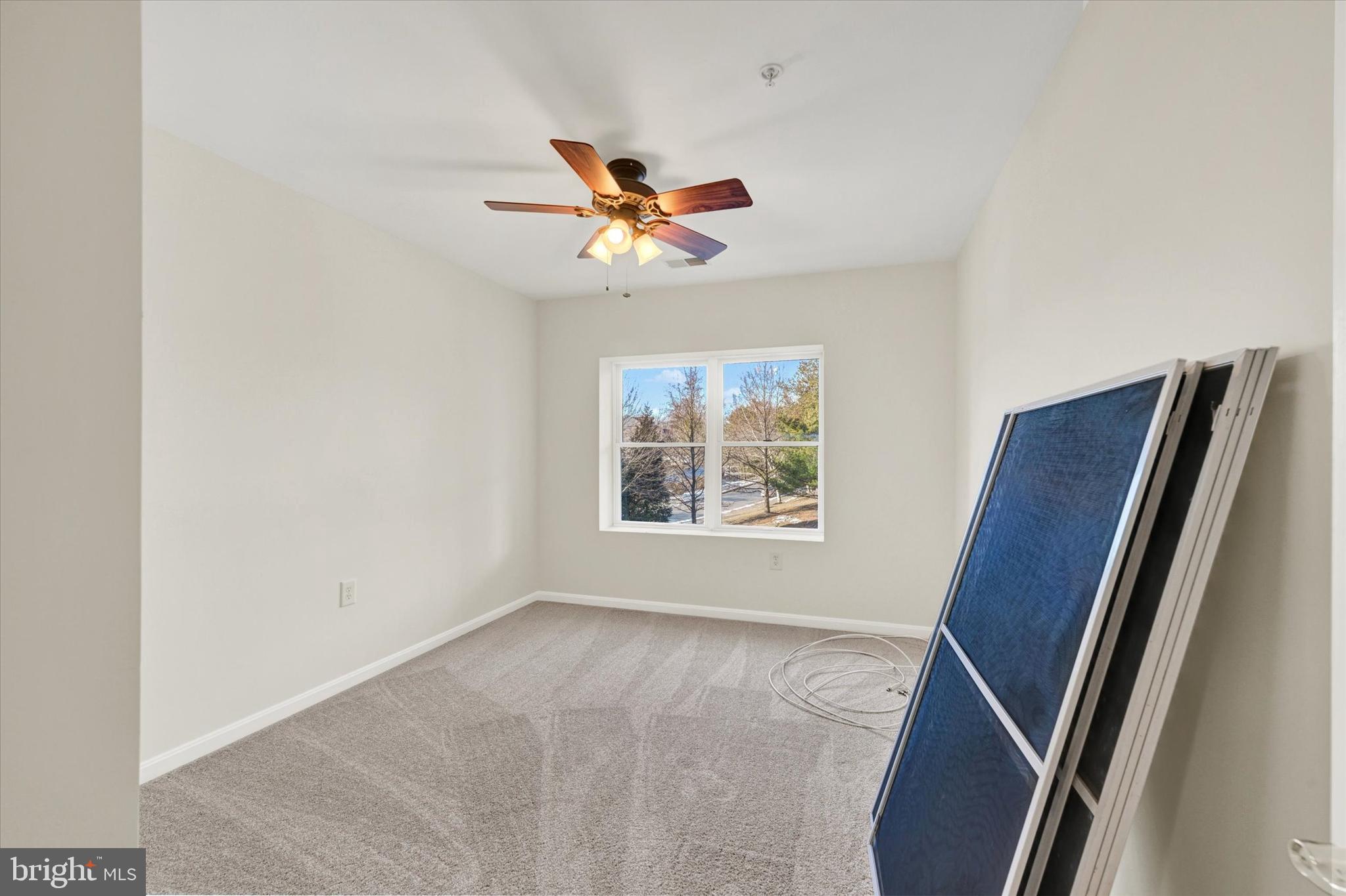 12236 Roundwood Road, Unit 104 Lutherville-Timonium, MD 21093 - Photo 16 of 27 a view of room with window and ceiling fan