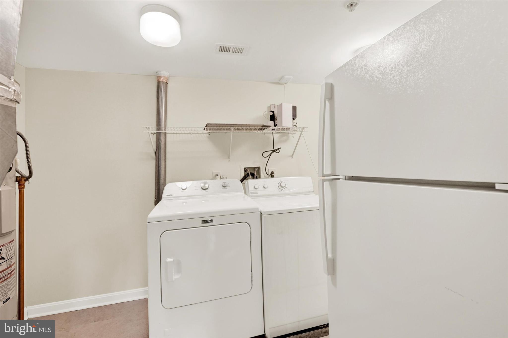 12236 Roundwood Road, Unit 104 Lutherville-Timonium, MD 21093 - Photo 17 of 27 a utility room with dryer and washer