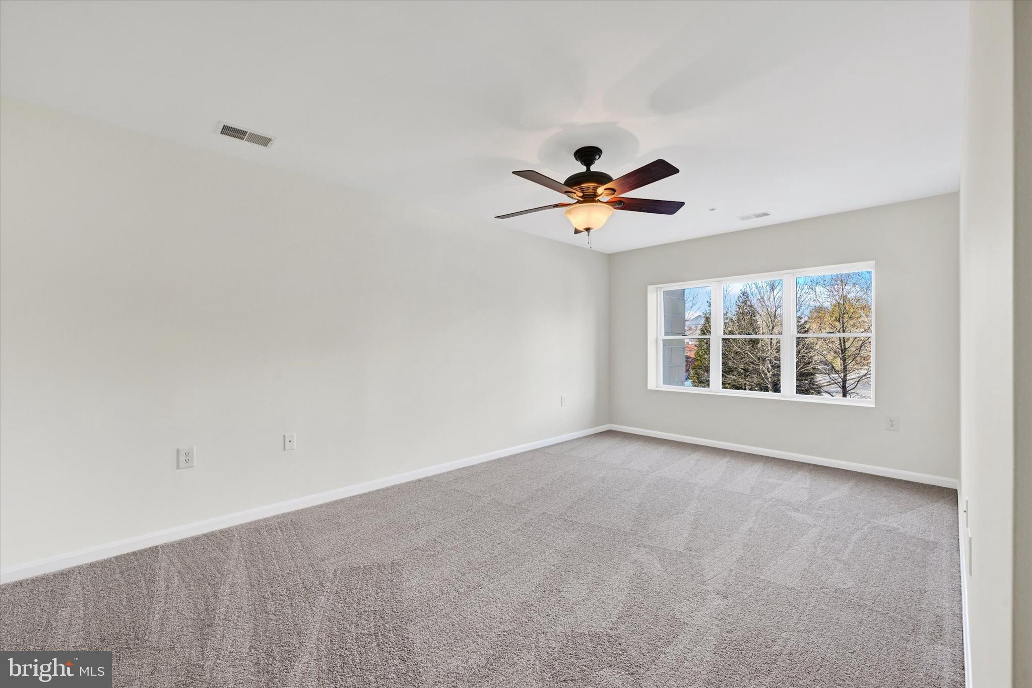 12236 Roundwood Road, Unit 104 Lutherville-Timonium, MD 21093 - Photo 21 of 27 a view of an empty room with a window