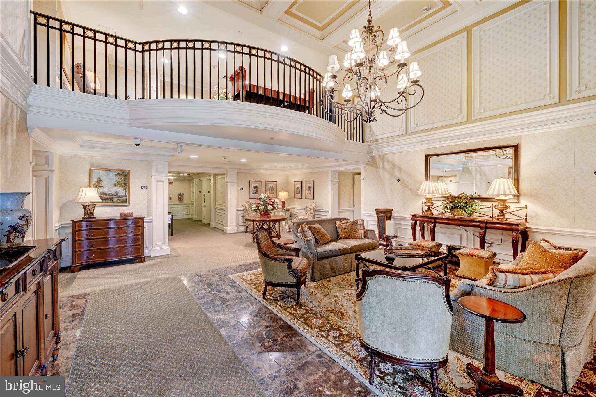 12236 Roundwood Road, Unit 104 Lutherville-Timonium, MD 21093 - Photo 26 of 27 a living room with furniture a chandelier and a dining table