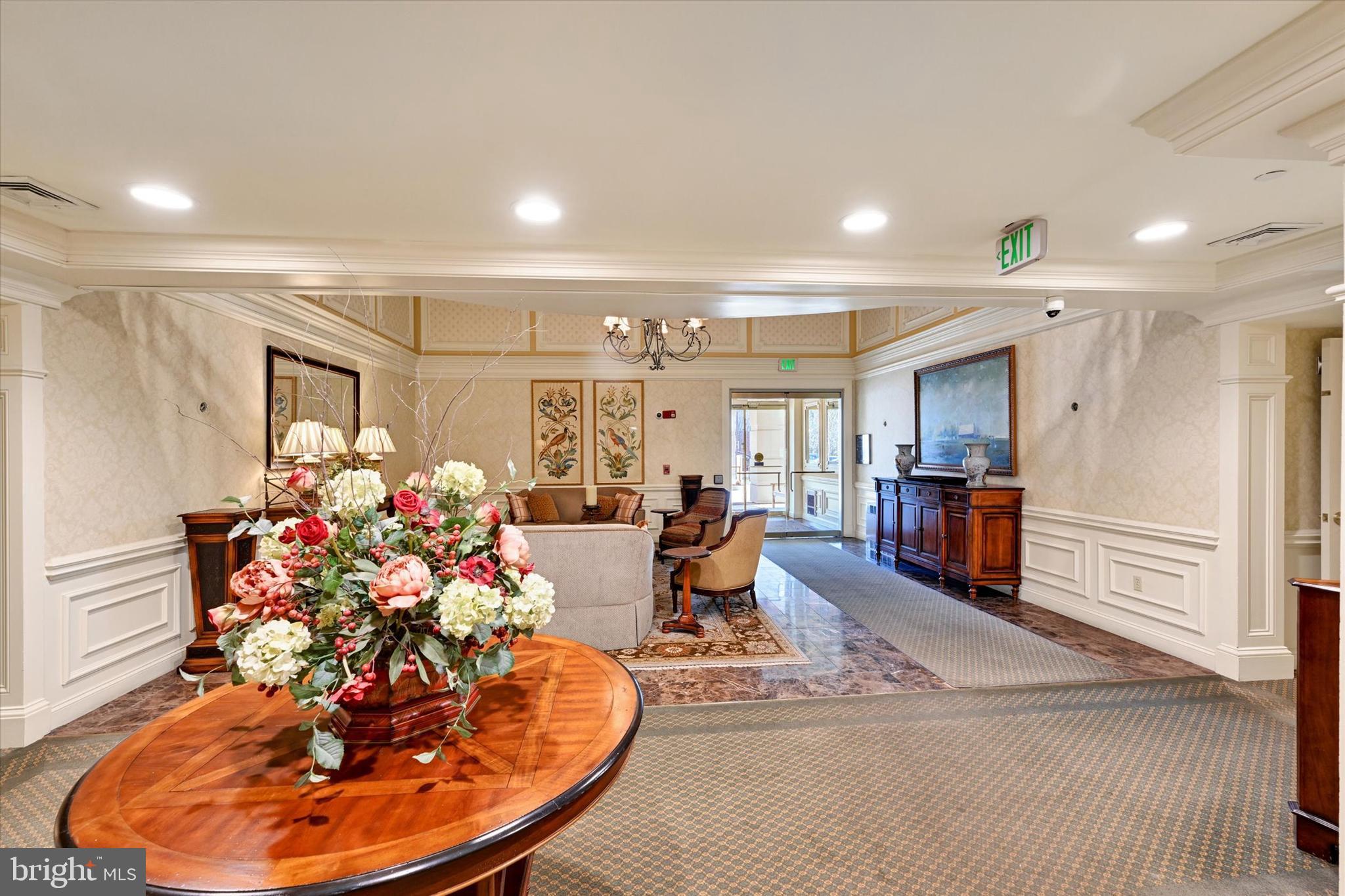 12236 Roundwood Road, Unit 104 Lutherville-Timonium, MD 21093 - Photo 27 of 27 a living room with furniture and a chandelier