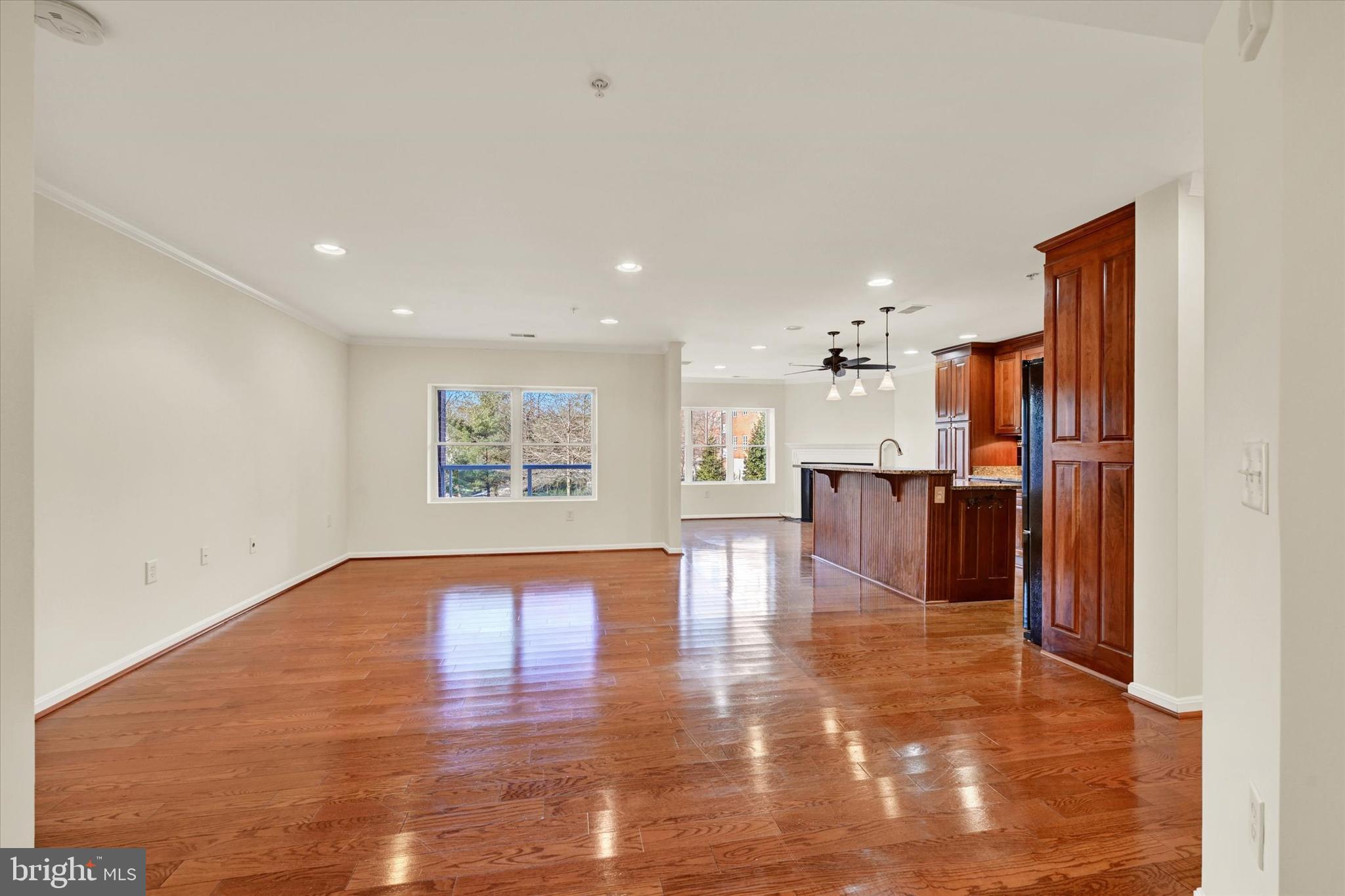 12236 Roundwood Road, Unit 104 Lutherville-Timonium, MD 21093 - Photo 4 of 27 a view of empty room with wooden floor and kitchen