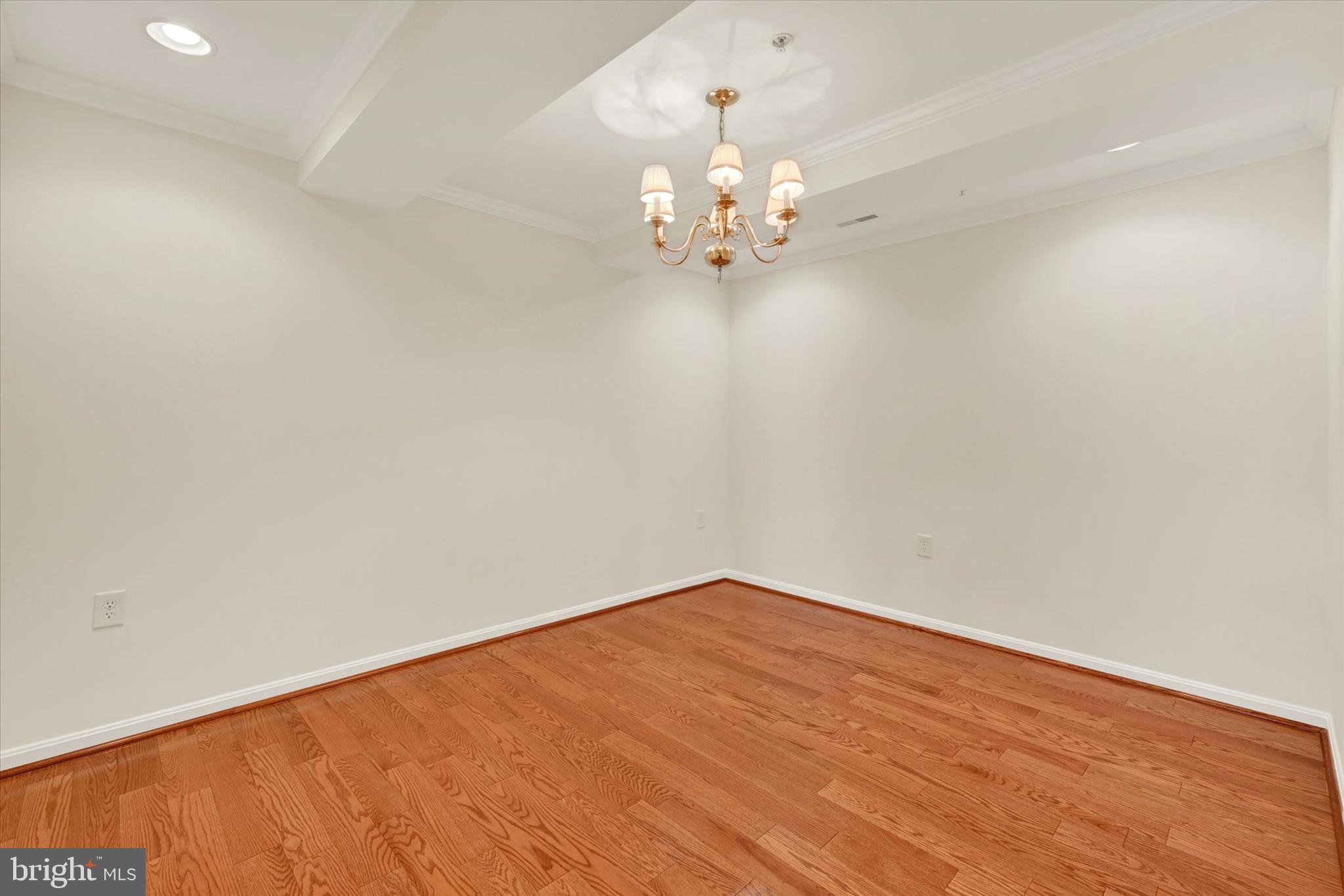 12236 Roundwood Road, Unit 104 Lutherville-Timonium, MD 21093 - Photo 5 of 27 en empty room with wooden floor