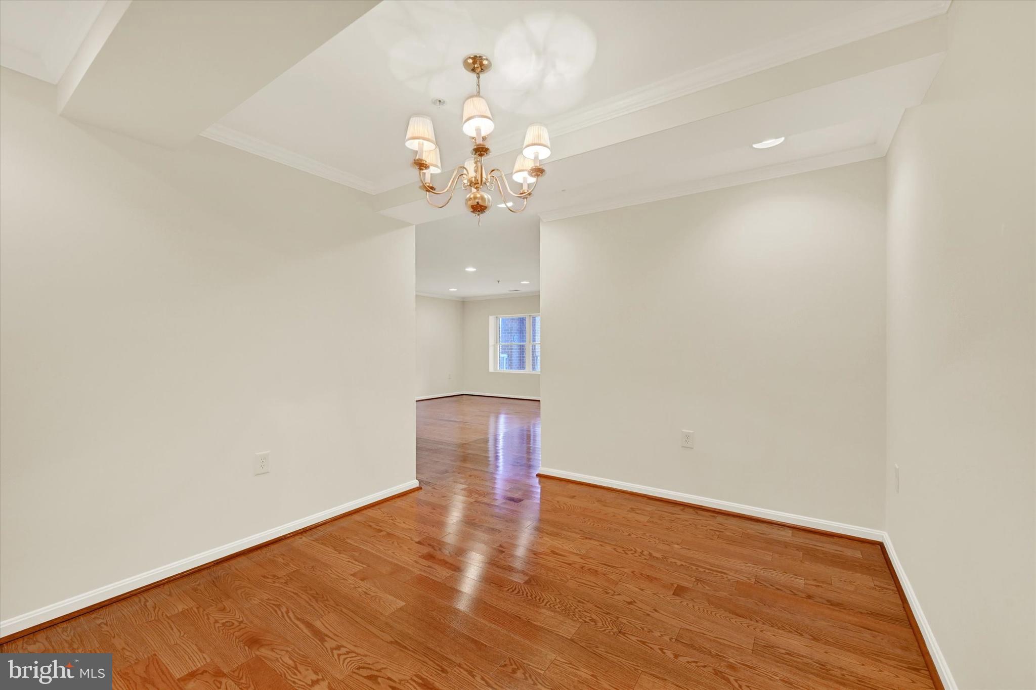 12236 Roundwood Road, Unit 104 Lutherville-Timonium, MD 21093 - Photo 6 of 27 wooden floor in an empty room with a window