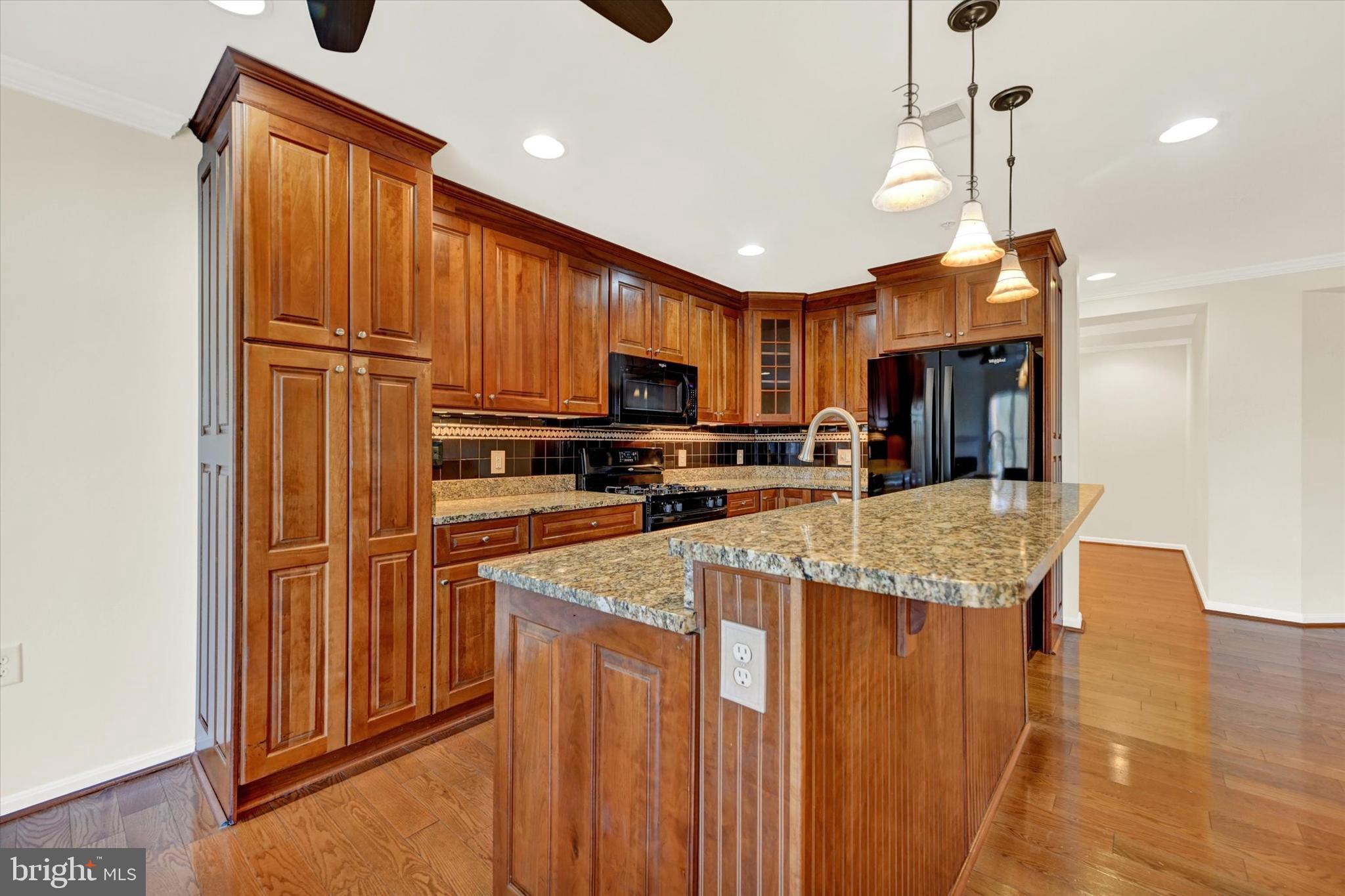 12236 Roundwood Road, Unit 104 Lutherville-Timonium, MD 21093 - Photo 8 of 27 a kitchen with stainless steel appliances granite countertop a refrigerator a stove top oven a sink and dishwasher