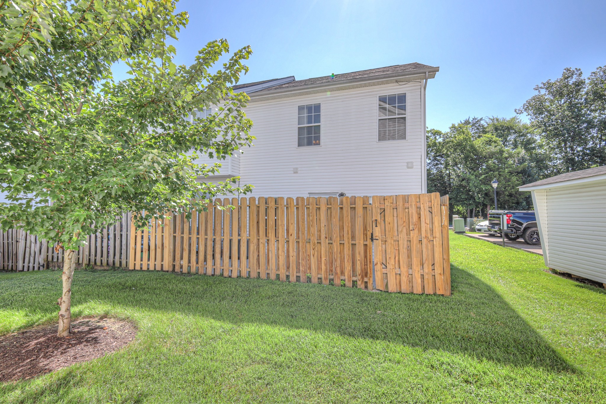 4027 Clinton Lane Spring Hill, TN 37174 - Photo 21 of 25 a backyard of a house with a garden and deck