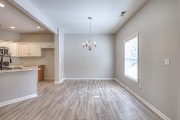 a view of a kitchen with a sink wooden floor and a window