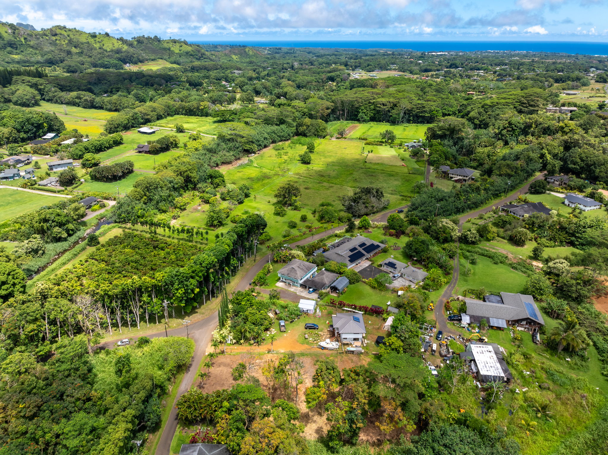 Moalepe Road Kapaa, HI 96746 - Photo 3 of 5 a view of a lush green forest with trees and houses in the back