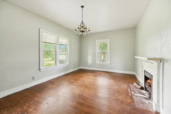 a view of livingroom with window fireplace and hardwood floor