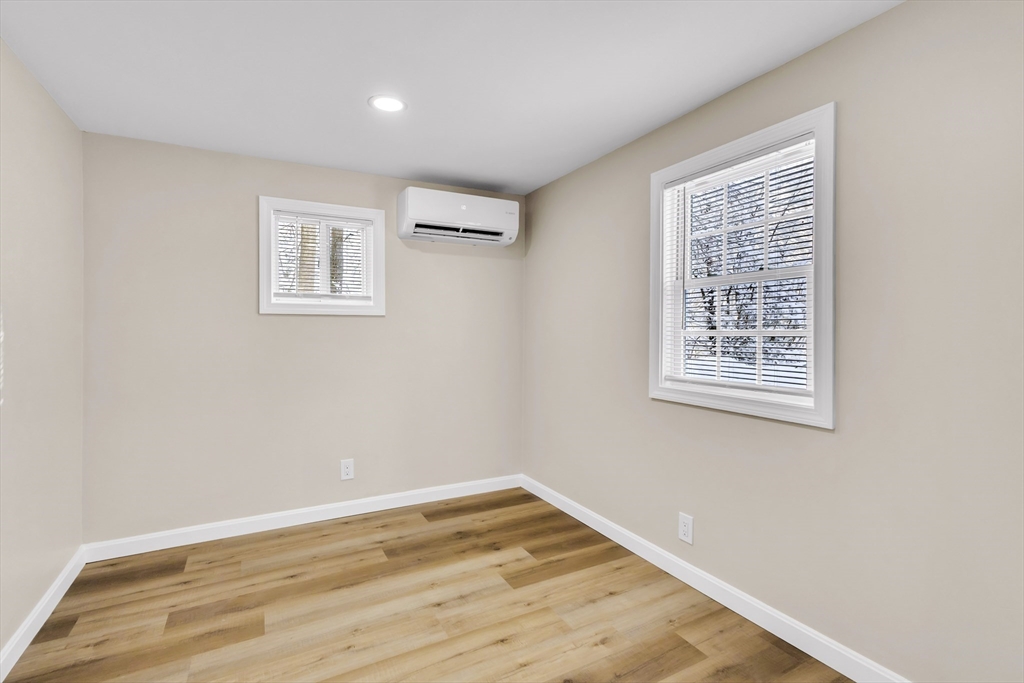 1 Columbia Road Billerica, MA 01821 - Photo 13 of 22 a view of an empty room with wooden floor and a window