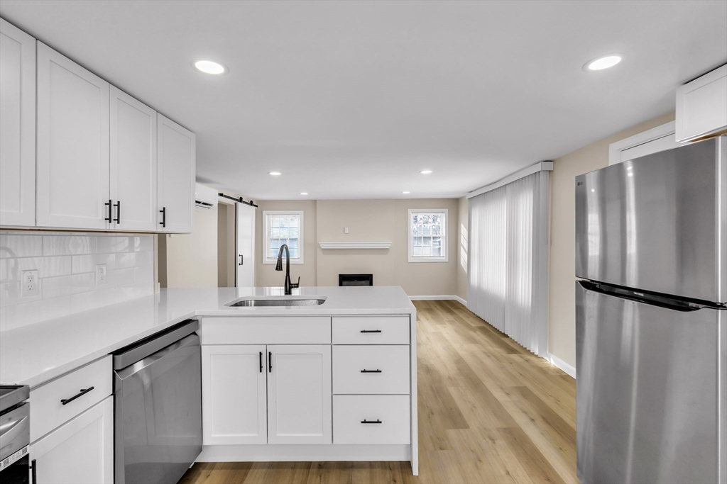 1 Columbia Road Billerica, MA 01821 - Photo 5 of 22 a kitchen with a sink stainless steel appliances and cabinets