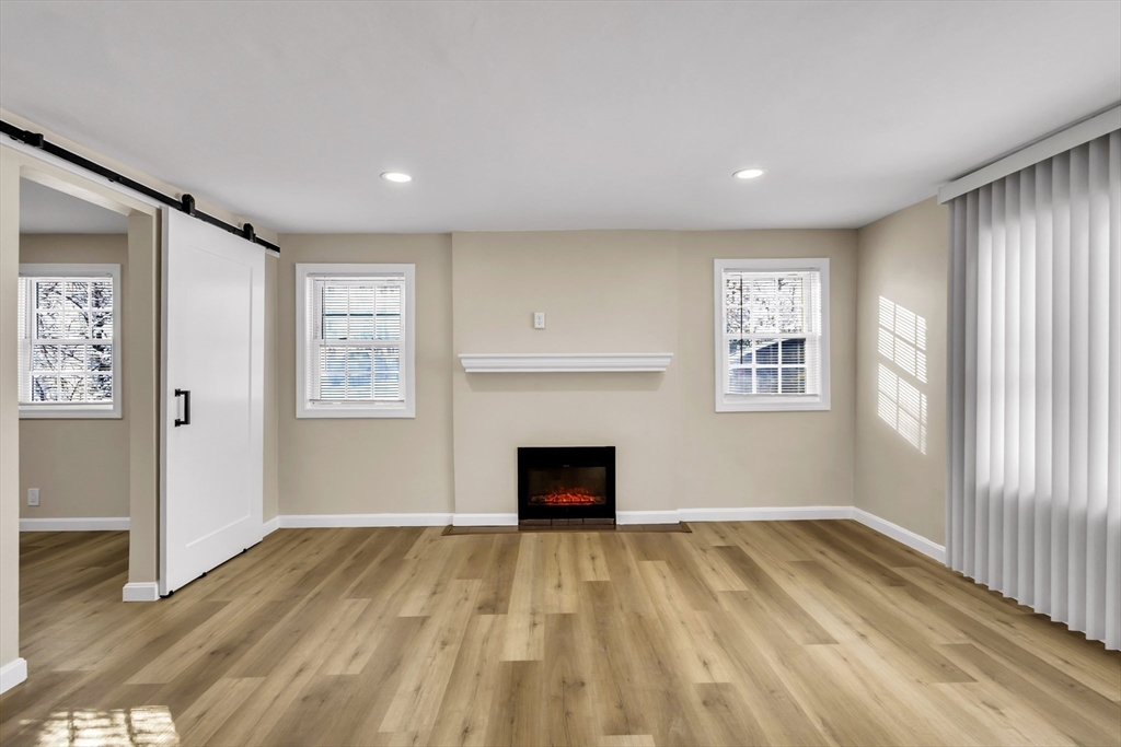 1 Columbia Road Billerica, MA 01821 - Photo 8 of 22 an empty room with windows and fireplace
