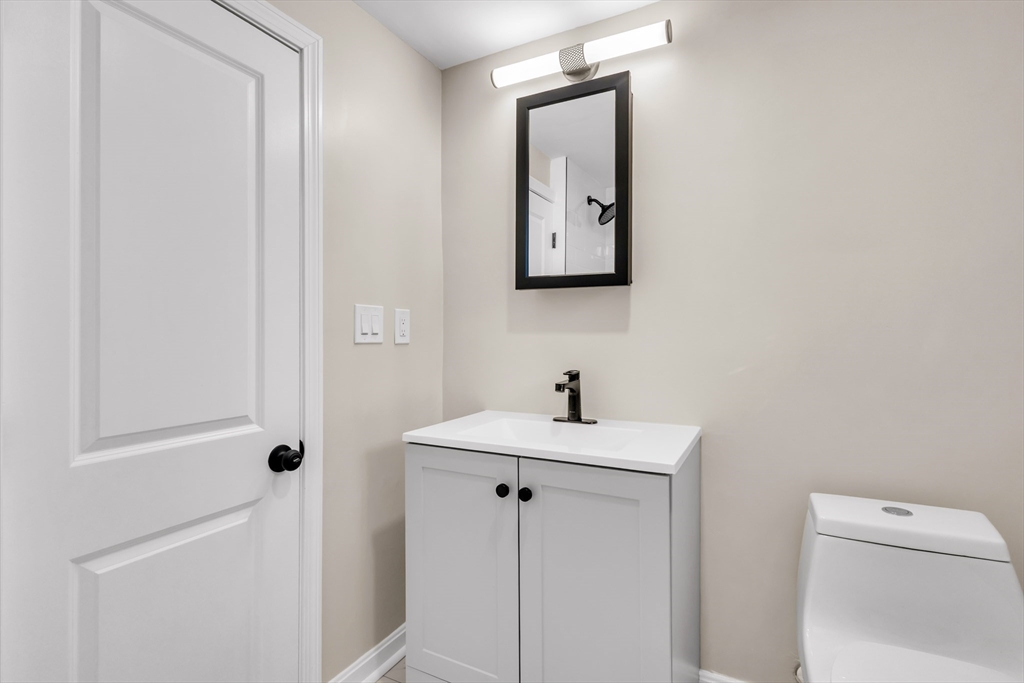 1 Columbia Road Billerica, MA 01821 - Photo 9 of 22 a bathroom with a sink a toilet and mirror
