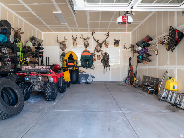 641 West 500 South Midway, UT 84049 - Photo 47 of 52 Spacious garage featuring a concrete floor, overhead garage door with opener, and a single window with blinds