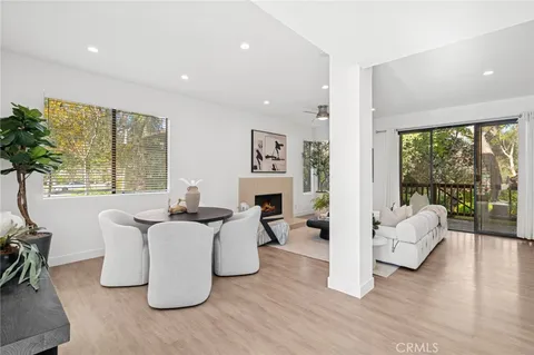 a living room with fireplace furniture and a large window