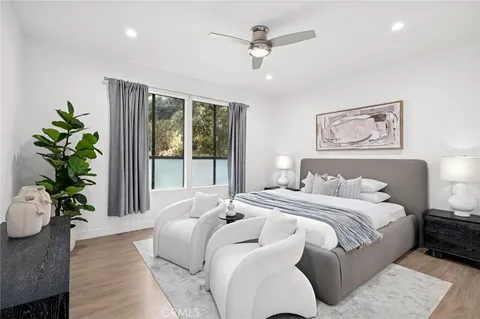 a spacious bedroom with a large bed and a potted plant